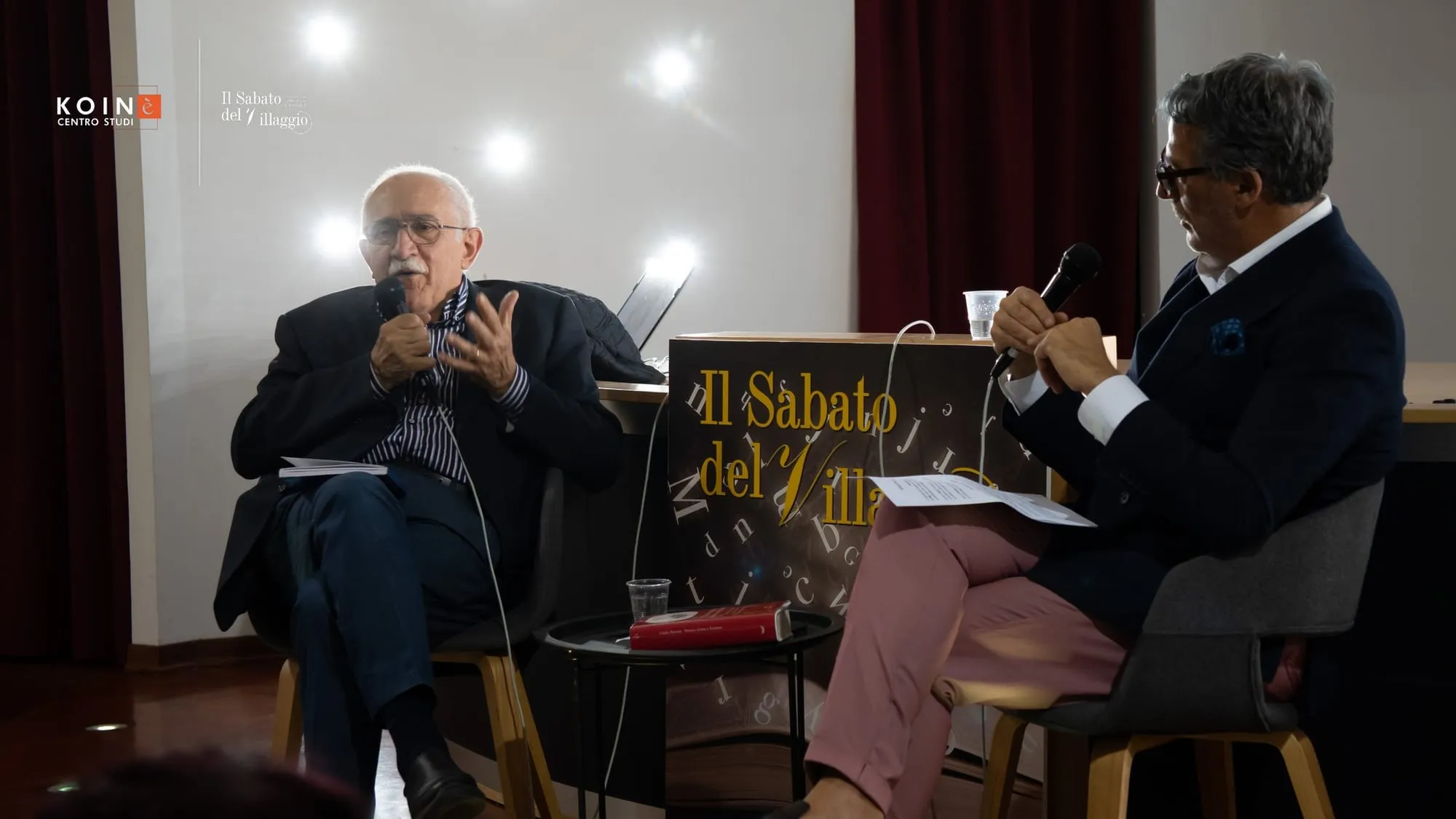 Conversazione tra due ospiti seduti in scena